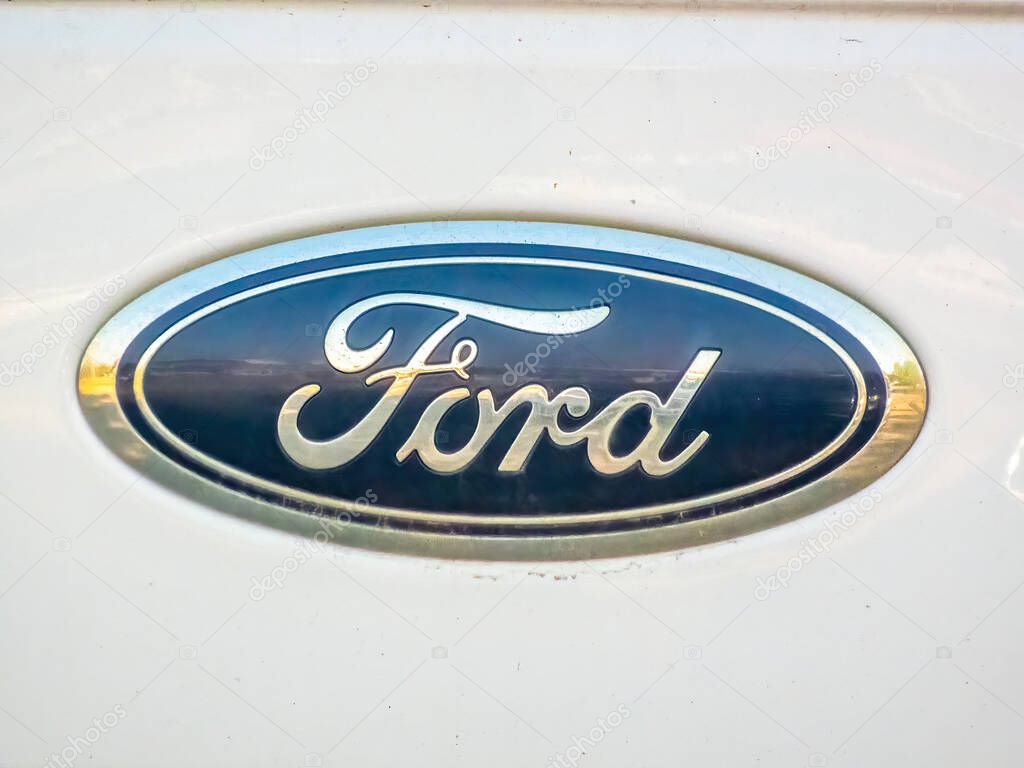 Calgary, Alberta, Canada. Jun 11, 2025. A close-up of the iconic Ford logo, an emblem of American automotive heritage, engineering, and global mobility.