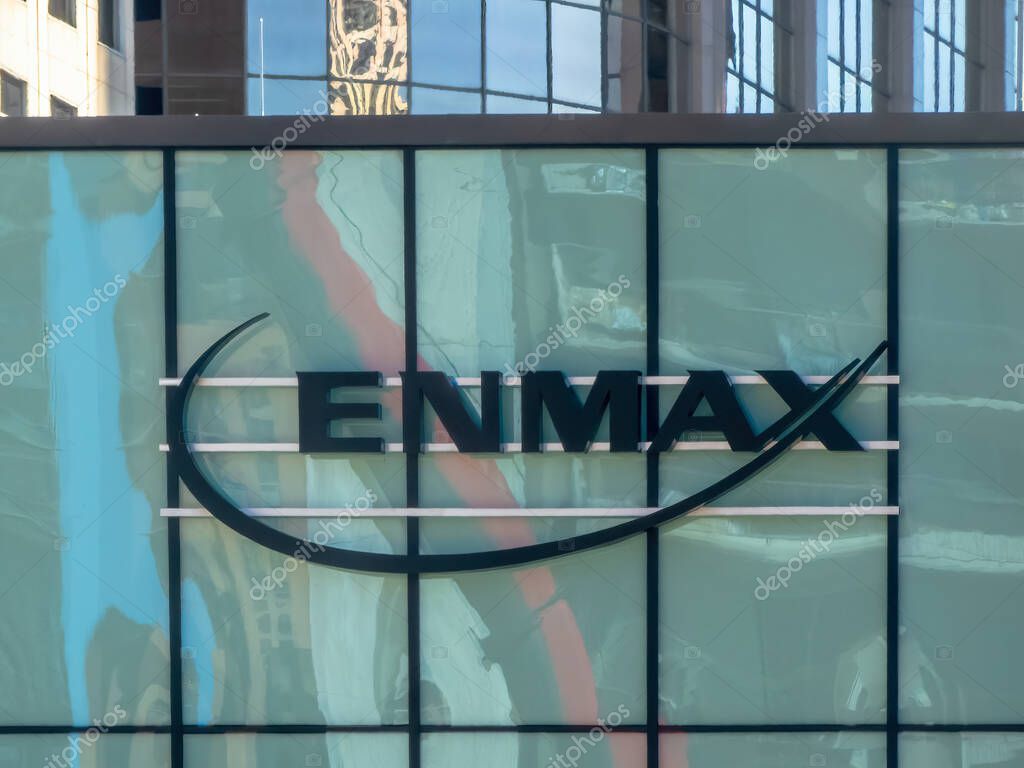 Calgary, Alberta, Canada. Aug 31, 2025. A shot of the ENMAX logo on a modern, multi-story glass building, reflecting the surrounding urban landscape and blue sky
