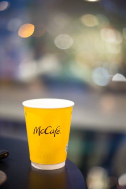 Prag, Çek Cumhuriyeti - 2 Şubat 2025: Bir McDonalds, fast food kültürü ve popüler içecekleri temsil eden yumuşak bir geçmişi olan bir masanın üzerinde dinlenen kahve fincanı. Yüksek kaliteli fotoğraf..