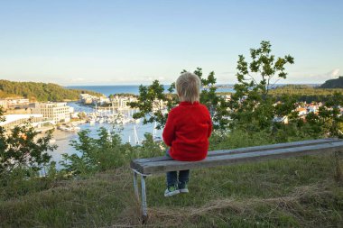 Family visiting town Mandal in Norway, view from the viewpoint Uranienborg to the city Mandal in Norway