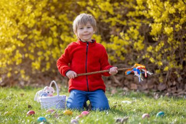 Cute preschool child, boy, holding handmade braided whip made from pussy willow, traditional symbol of Czech Easter used for whipping girls and women to receive eggs and sweets