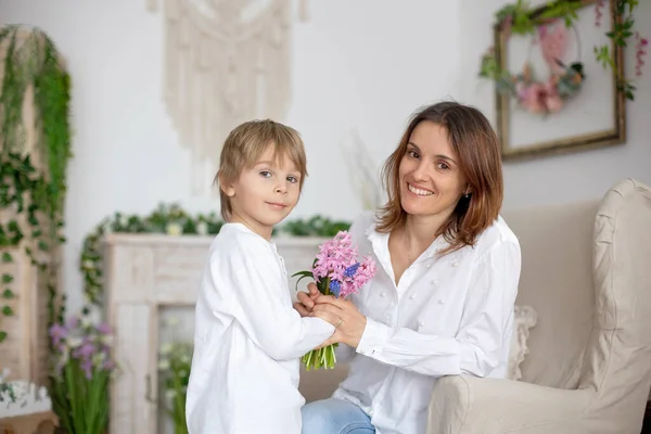 Cute Little Boy Giving Flowers His Mom Mothers Day Home — Stock Photo, Image
