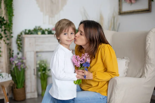 かわいい男の子 自宅で母の日のための彼のお母さんに花を与える 居心地の良い場所 — ストック写真