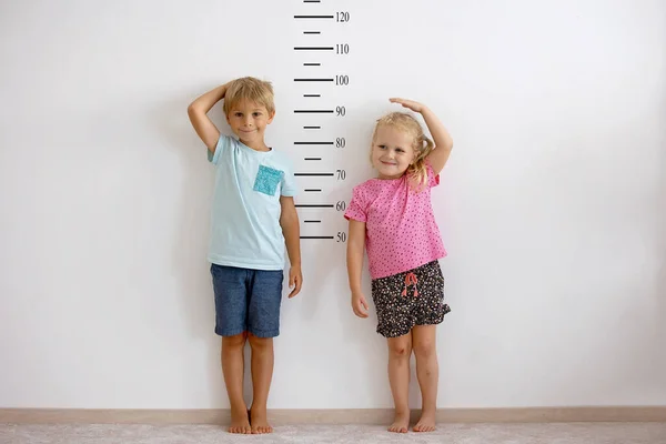 Little Children Blond Boy Girl Measuring Height Wall Room Comparing — Stock Photo, Image