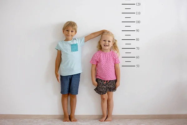Little Children Blond Boy Girl Measuring Height Wall Room Comparing — Stock Photo, Image