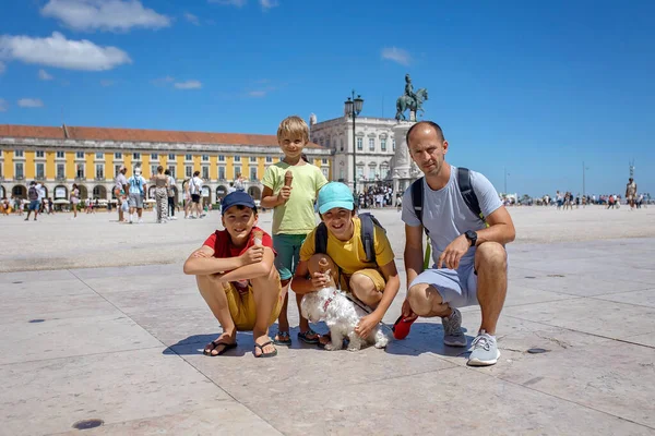 Happy people, visiting Lisbon during summer holiday, family with children in the old city