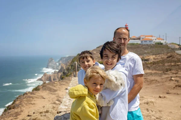 Family with children, siblings, visiting the most west point of Europe, Cabo Da Roca, during family vacation summertime in Portugal