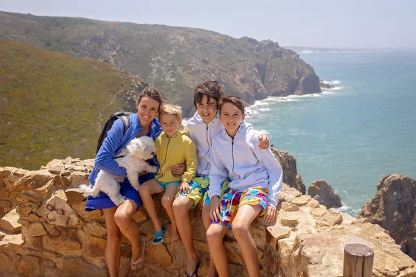 Family with children, siblings, visiting the most west point of Europe, Cabo Da Roca, during family vacation summertime in Portugal