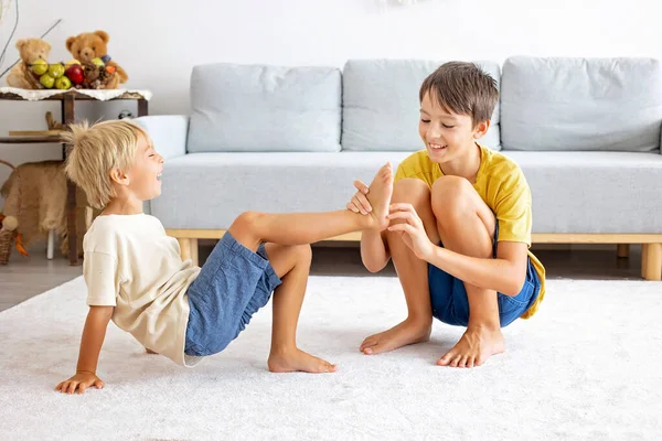 Mutlu pozitif çocuklar, ayaklarınızı gıdıklayarak, birlikte eğlenerek, evde erkek kardeşler birlikte harika bir gün geçiriyorlar.