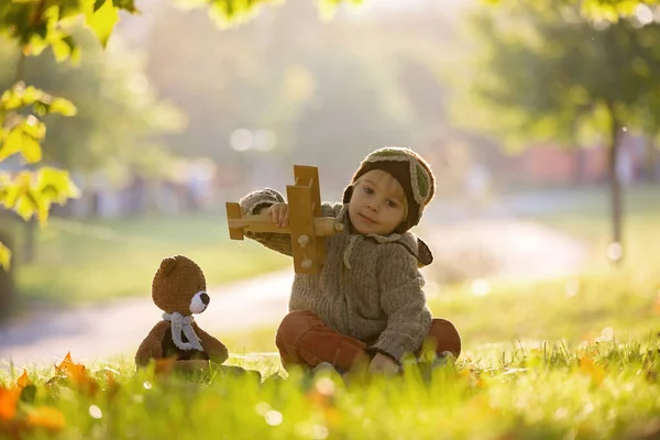 Little Toddler Child Boy Playing Airplane Knitted Teddy Bear Autumn — Stock Photo, Image