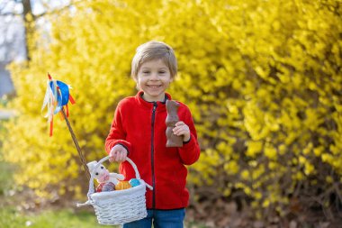 Cute preschool child, boy, holding handmade braided whip made from pussy willow, traditional symbol of Czech Easter used for whipping girls and women to receive eggs and sweets