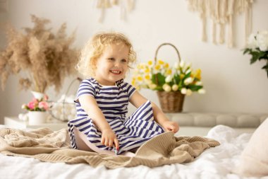 Happy children, siblings, enjoying Easter holiday together, tradition with handmade twig, braided whip made from pussy willow, traditional symbol of Czech Easter