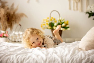 Happy children, siblings, enjoying Easter holiday together, tradition with handmade twig, braided whip made from pussy willow, traditional symbol of Czech Easter