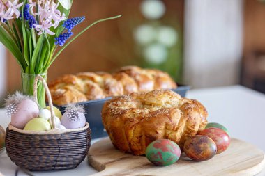 Tatlı anaokulu çocuğu, Paskalya için tatlı brioche ekmeği tutuyor. Badem, fındık ve şekerle pişirilmiş geleneksel tatlı ekmek.