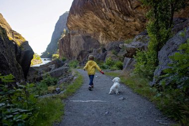 Happy people, enjoying amazing views in South Norway coastline, fjords, lakes, beautiful nature. Kids and adults traveling in Norway summertime