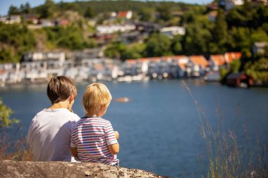 Children, family, visiting small village Flekkefjord during summer vacation in Norway clipart
