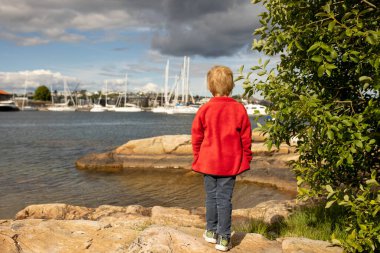 Beautiful town Kristiansand in Norway, family visiting Norway for summer vacation, kids enjoying amazing views clipart