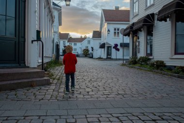 Family visiting town Mandal in Norway, enjoying amazing views, kids playing on sunset