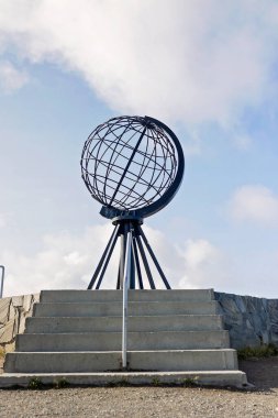 Family with children and pet dog, visiting Nordkapp during the summer holiday. Kids and adult visiting the famous globe on North Cape clipart