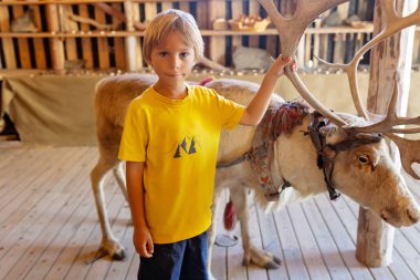 Family with children and pet dog, visiting Nordkapp during the summer holiday. Kids and adult visiting the famous globe on North Cape clipart