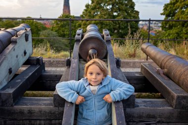 Family with children and pet dog, kids and adults visiting nortern cities in Sweden, Uppsala clipart