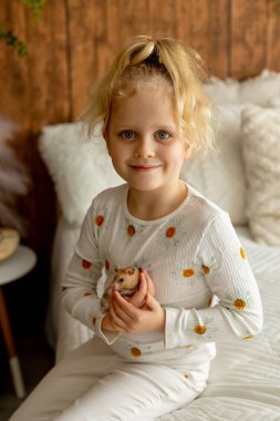 Sevimli küçük çocuklar, sarışın oğlan ve kız, evde küçük kobayla oynuyorlar, bebek hayvan ve çocuk.