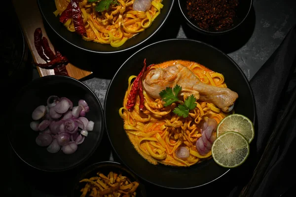 stock image Top view, Traditional northern Thai food concept, Delicious and tasty spicy creamy curry soup with chicken and egg noodles or Khao Soi Kai.