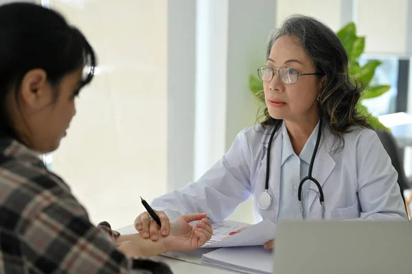 Professional Asian Senior Female Doctor Examining Patient Her Cliic Office Stock Photo