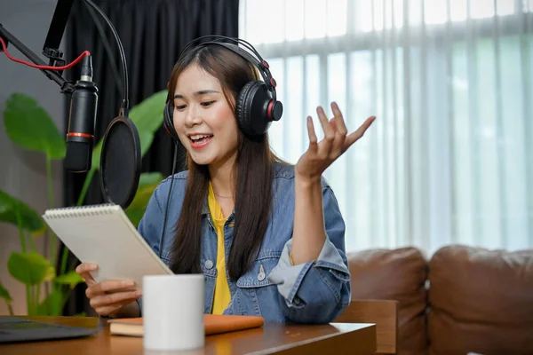 stock image Happy asian girl record a podcast with headphones and microphone. Female podcaster make audio podcast from her home studio.