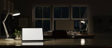 Portable digital tablet white screen mockup with wireless keyboard, table lamp, decor plant and copy space on tabletop over dark home office studio in the background. 3d render, 3d illustration