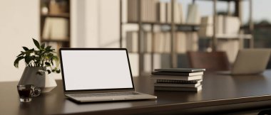 close-up image, Notebook laptop white screen mockup is on a modern office desk with stack of book, decor plant and a cup of coffee. 3d render, 3d illustration