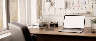 close-up image, Modern minimal home office workspace with notebook laptop white screen mockup, accessories and decor on wood table near the window, pegboard on white wall. 3d render, 3d illustration