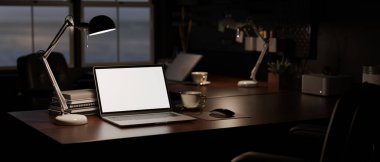 close-up image, Modern dark office at night with notebook laptop white screen mockup, light from table lamp, and office accessories on dark wooden desk. 3d render, 3d illustration