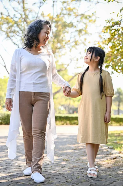 Lovely Asian Grandmother Granddaughter Holding Hands Walking Summer Park Together — Fotografia de Stock
