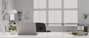 Modern doctor office with laptop, table lamp, stationery and decor on white table over blurred background. doctor's office, examination room. 3d render, 3d illustration