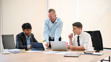 Group of diverse businesspeople are having a financial meeting in the meeting room, discussing a financial investment plan, analyzing financial data, and working together.