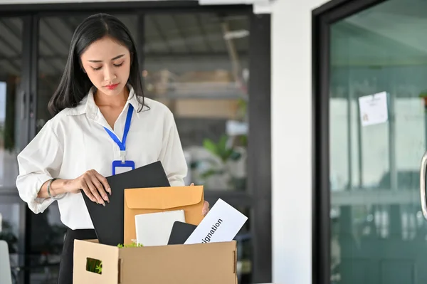 Sad Upset Millennial Asian Female Office Worker Packing Her Stuff — Stock fotografie