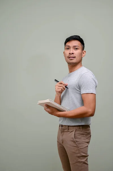 Smart Millennial Asian Man Casual Clothes Holding Pen Book While — Stock Photo, Image