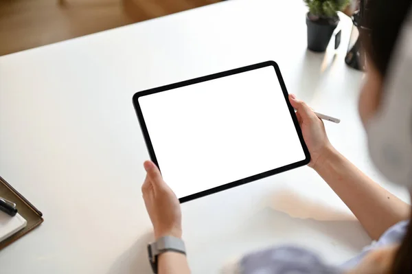 stock image Close-up image of young Asian woman using her digital tablet at her workspace. tablet white screen mockup