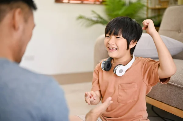 귀엽고 아시아인 아버지와 가위를 가지고 놀면서 가족들 거실에서 재미있게 시간을 — 스톡 사진