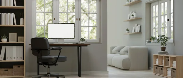 stock image Minimal white home working space interior design with computer white screen mockup on a table against the window, office chair, shelf, and living room. 3d render, 3d illustration