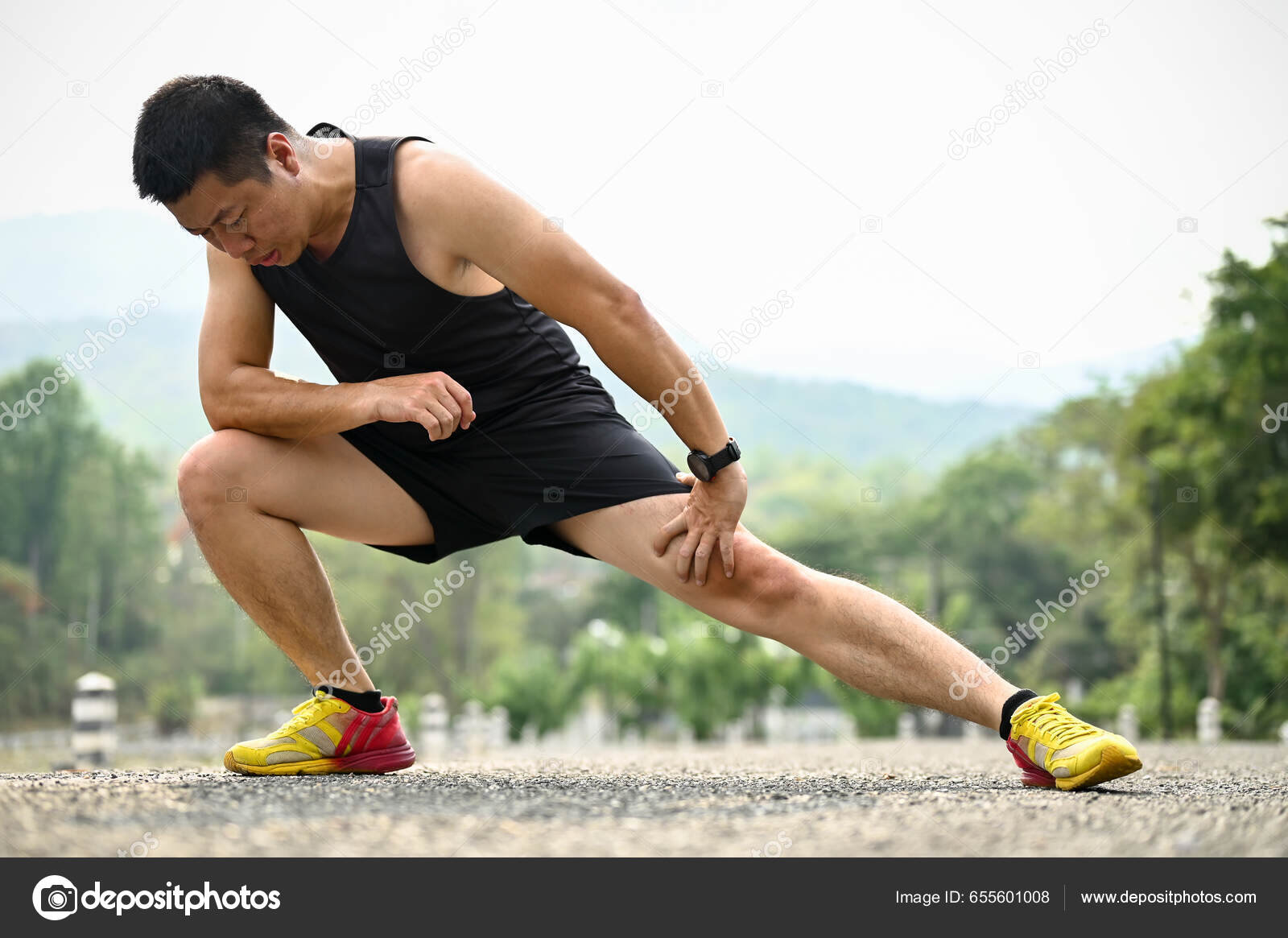 Sporty man jogging in a park stock photo