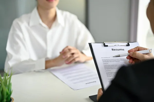 stock image Close-up image of a professional recruiter or HR manager reading a candidate's resume during a job interview.