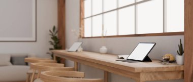 Dijital tablet beyaz ekran maketi pencereye dayalı ahşap bir masanın üzerinde duran rahat, minimal kafe ya da ortak çalışma alanı. Yakın plan görüntü görüntü çalışma alanı. 3d görüntüleme, 3d illüstrasyon