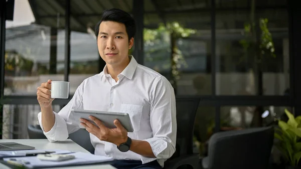 책상에 앉아서 디지털 태블릿을 성공적 밀레니엄 아시아 사업가 — 스톡 사진