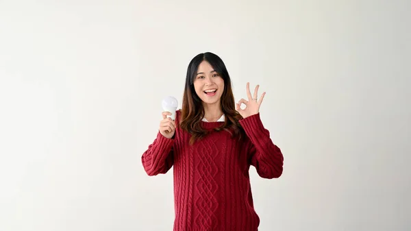 Positive Smiling Young Asian Female Red Sweater Holding Light Bulb — Stock Photo, Image