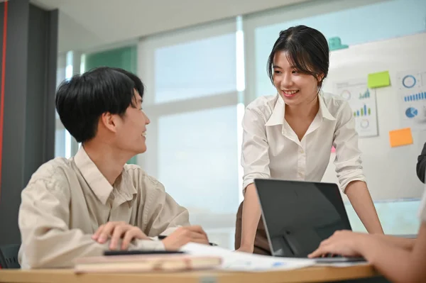 Attractive Cheerful Young Asian Businesswoman Listening Her Male Colleague Ideas — Stock Photo, Image