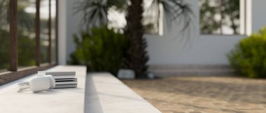 Modern kablosuz kulaklıkların ve modern tropikal odalarda bulunan çimento bir merdivenin üzerindeki kitapların yakın plan görüntüsü. 3d görüntüleme, 3d illüstrasyon