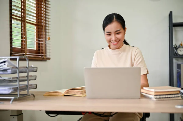 stock image Young beautiful Asian woman working in her home office with laptop computer. 