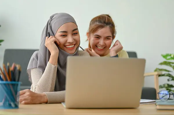 stock image Cheerful muslim woman and her friend watching movies together in their free time